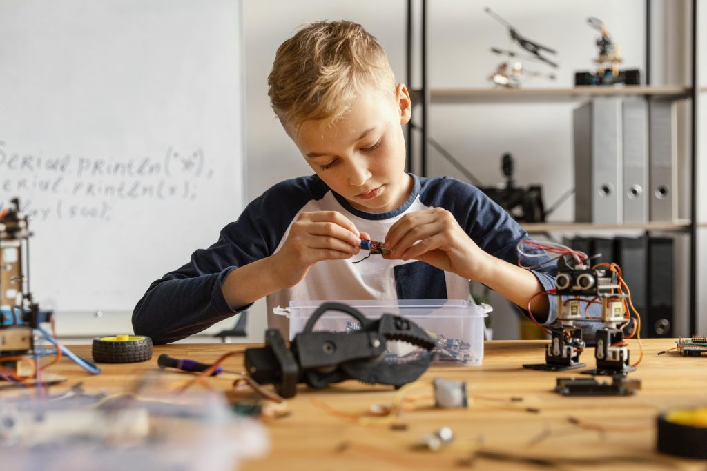 A boy building robots with parts.